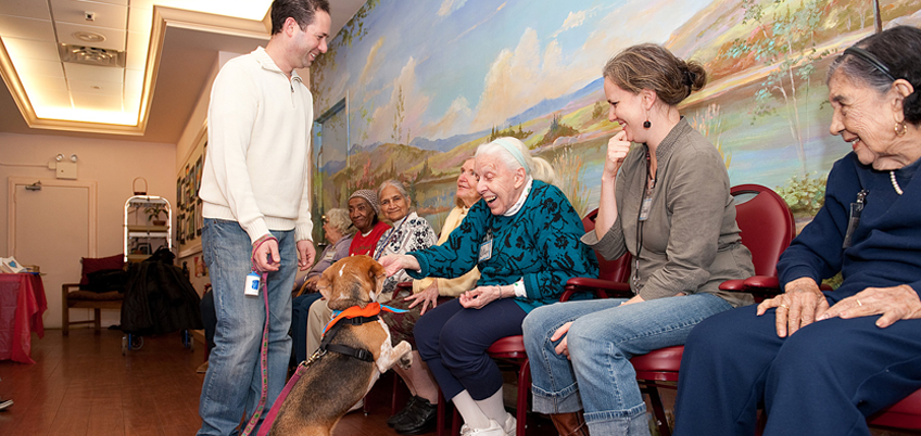 A therapy dog and her owner delight members of the SCS Social Adult Day Program